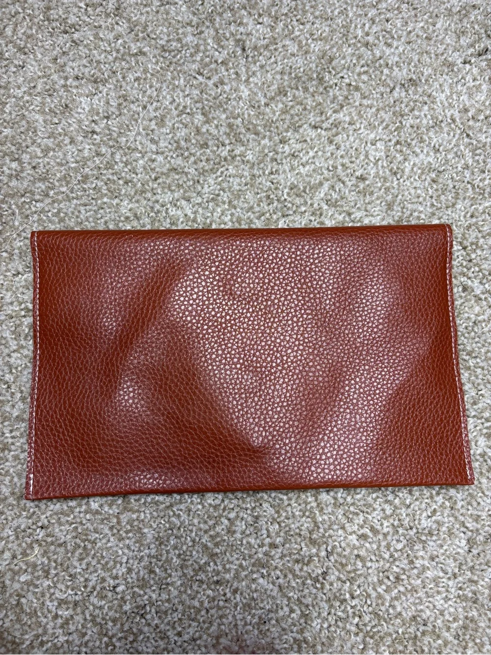 Monogram Convertible Clutch in Rust Brown